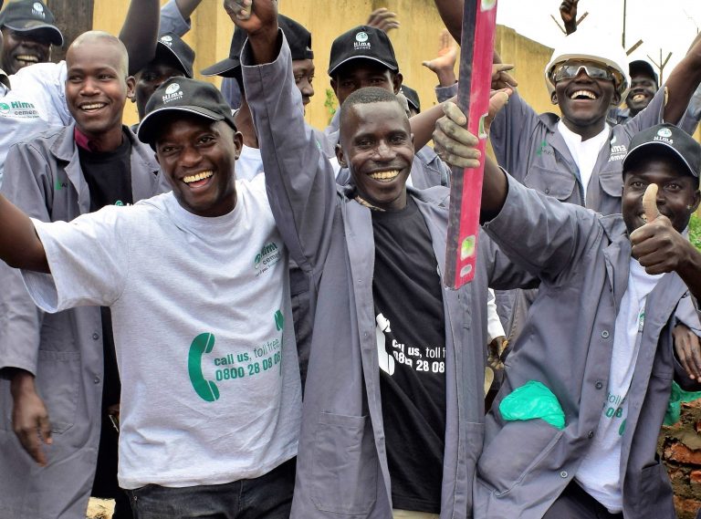 Jseph Balikudembe (in white t-shirt) joins masons and foremen who attended Hima Cement's Builders Academy in Lira