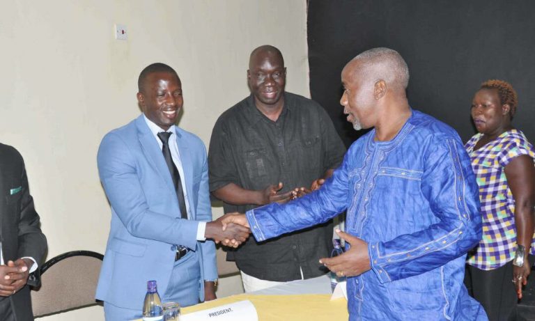AIBA's representative John kameta, the President of Kenya Boxing Federation welcomes Muhangi (in blue suit) into office