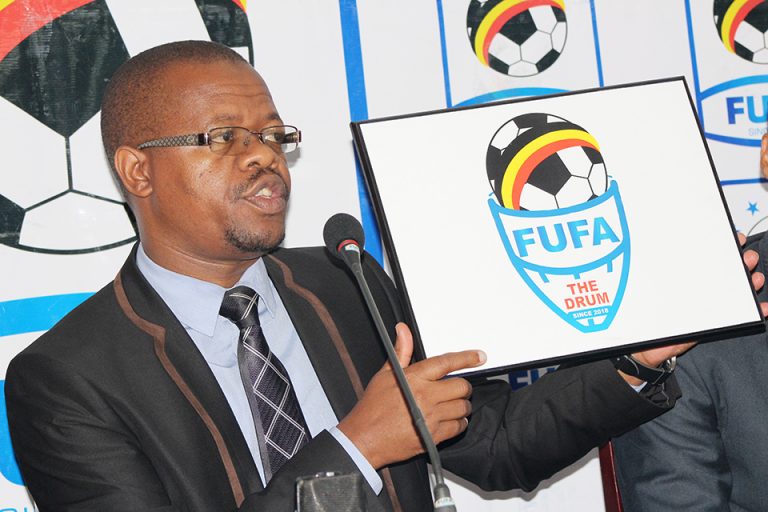 FUFA-President-displaying-the-Official-Logo-of-the-new-Tournament-for-the-16-Provinces