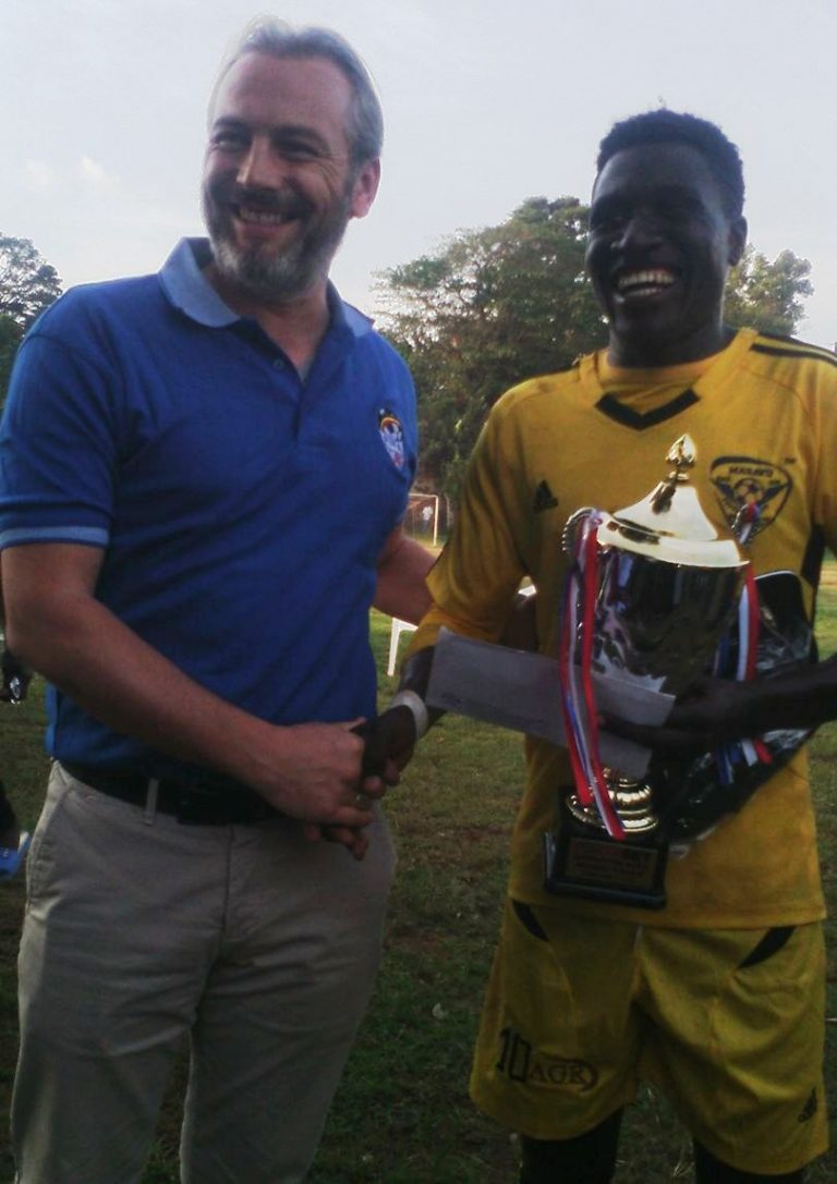 Ndugwa receives his man of the match accolade from Uganda Cranes coach Sebastien Desabre