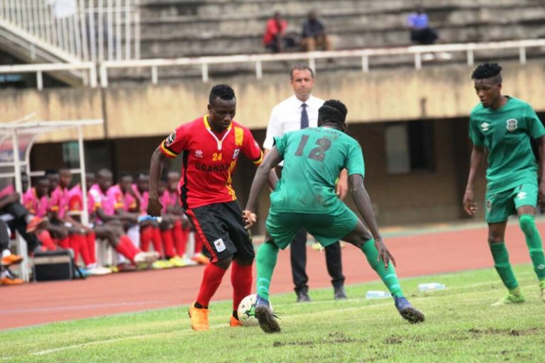 Yunus Sentamu attempts a drible past Precious Sambani of Malawi on Tuesday in an international friendly at Namboole