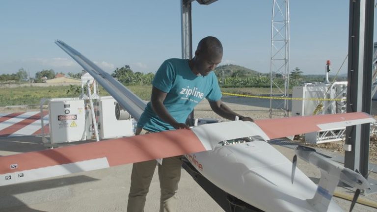 Abdoul Salam Nizeyimana preparing a delivery drone for launch.