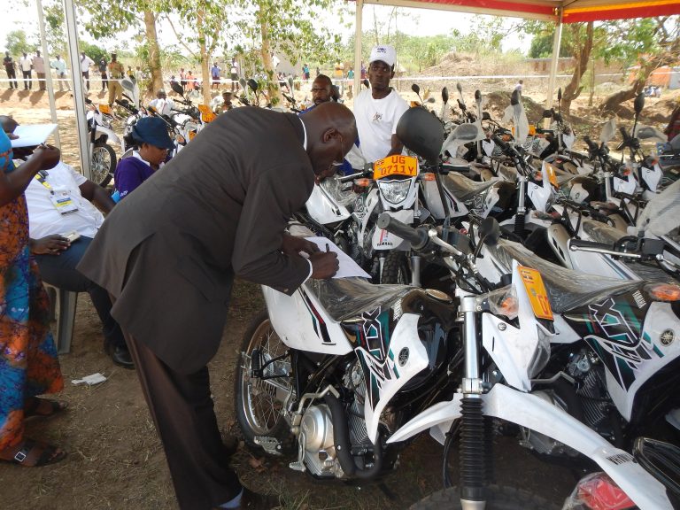 District officials sign for UWEP motorcycles to aid programme implementation