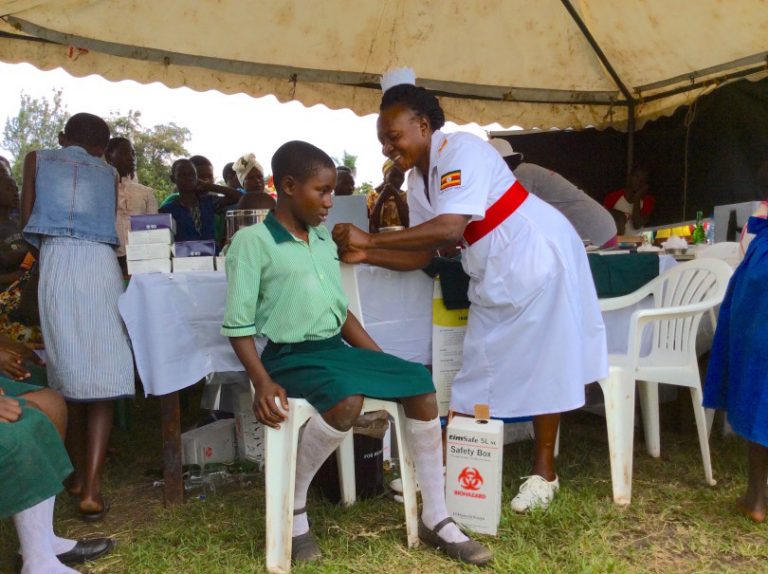 A-school-girl-in-Uganda-receives-a-vaccination-from-a-nurse.-Photo-PATHBrian-Atuhaire.-810x605