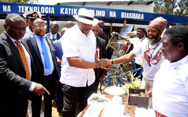 President Uhuru Kenyatta is introduced to Small and Medium Enterprises exhibitors by the Kenya National Chamber of Commerce and Industry President Richard Ngatia at the 2019 Nairobi ASK show. Looking on is Nairobi Governor Mike Mbuvi Sonko. [File, Standard]