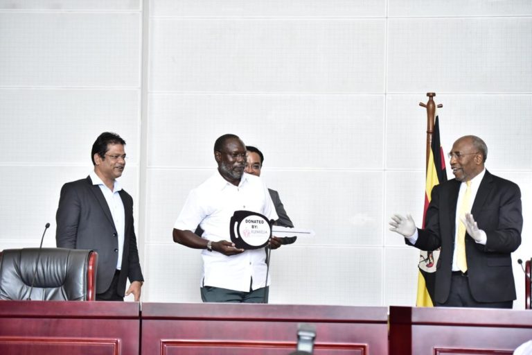 Bongo (C) handing over car keys to Premier Rugunda