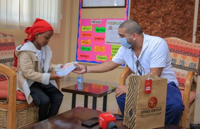 Fresh Kid receiving his tablet from Rajiv
