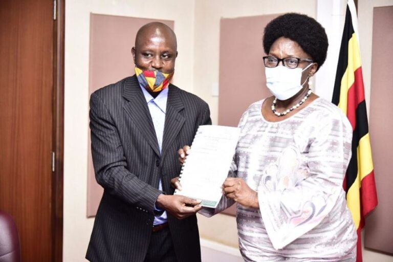 Kadaga receiving the petition from Rural Broadcasters Association