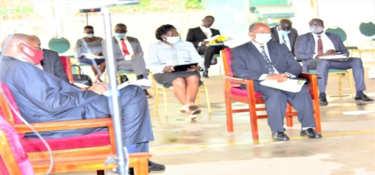 Minister for Higher Education, Dr John Muyingo listens