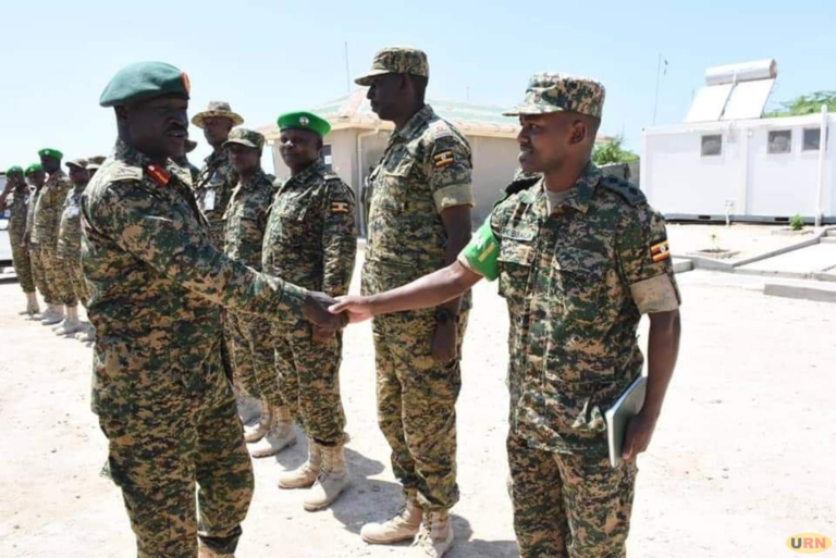 Gen Peter Elwelu greeting senior army officer at UPDF Contingent in Somalia
