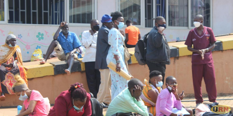 Patients and caretakers outside one of the shelters at Uganda Cancer Institute