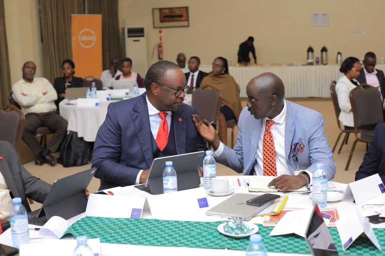 BOU ED Supervision Tumubweine chats with Absa Bank MD Mumba Kalinfugwa during the training