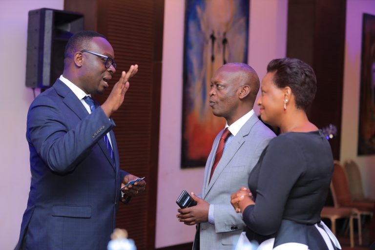 Julius Kakeeto, the Chief Executive Officer at PostBank speaking to some clients