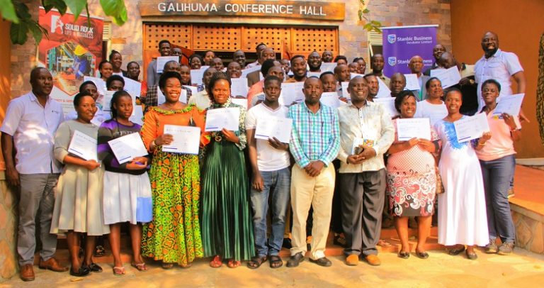 Participants posing for a photo with their certificates after the training at Kabalega Resort Hotel in Hoima city on Wednesday