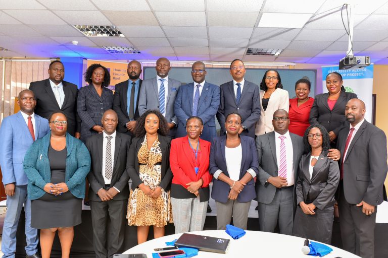 A group photo of the Housing Finance Bank Executive teams and UECCC executive teams during the launch of the partnership at the bank Headquaters in Kololo
