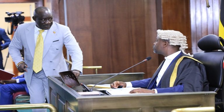 Minister Ecweru (L) consults Tayebwa before he made his responses on the matters raised by the MPs