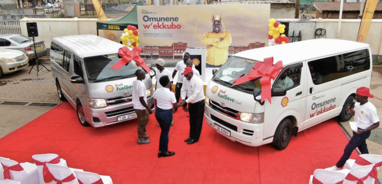 Managing Director of Vivo Energy, Joanita Mukasa Menya handing over Toyota passenger vans to Richard Atiku from Masindi and Ismail Mulumba from Gayaza.