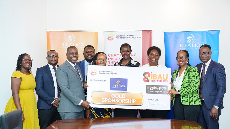 ICEA LION CEO Ambrose Kibuuka(Grey Suit) holds the Dummy Cheque presenting the Gold Sponsorship by the Insurance giants for the 8th IBAU conference.Lookig on are officials from IBAU and ICEA LION