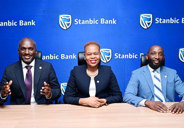 Israel Arinaitwe Head Personal Banking maing remarks, looking on is Yvone Namutosi, Head Digital Banking and E-Commerce and Arthur Kiwanuka Head Affluent Banking at Stanbic Bank Uganda