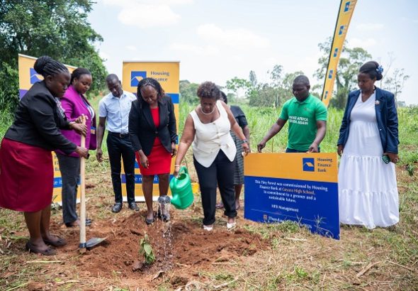Team From Housing Finance Bank and Gayaza High School plant a tree at the school farm after handing over 120 trees to the school. (1)