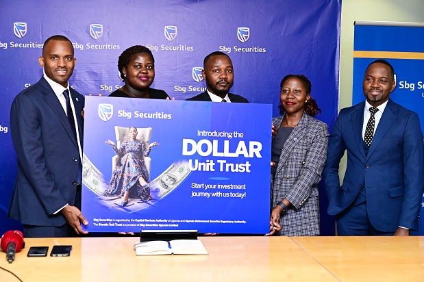 The SBG Securities team led by the Chief Executive Grace Semakula(left). Right is Stanbic Bank's Country Manager for Communication and Reputation, Kenneth Agutamba.