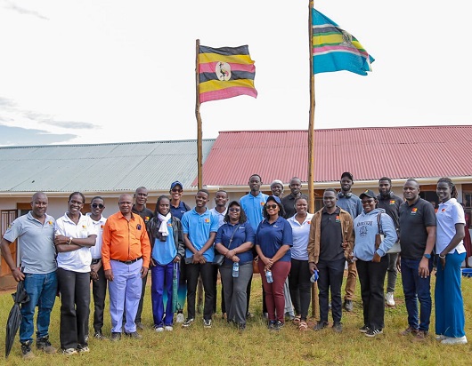 dfcu Bank, Mastercard Foundation Scholars Program representatives, Bwera Primary School management and community members unite to celebrate a shared achievement in one group photo