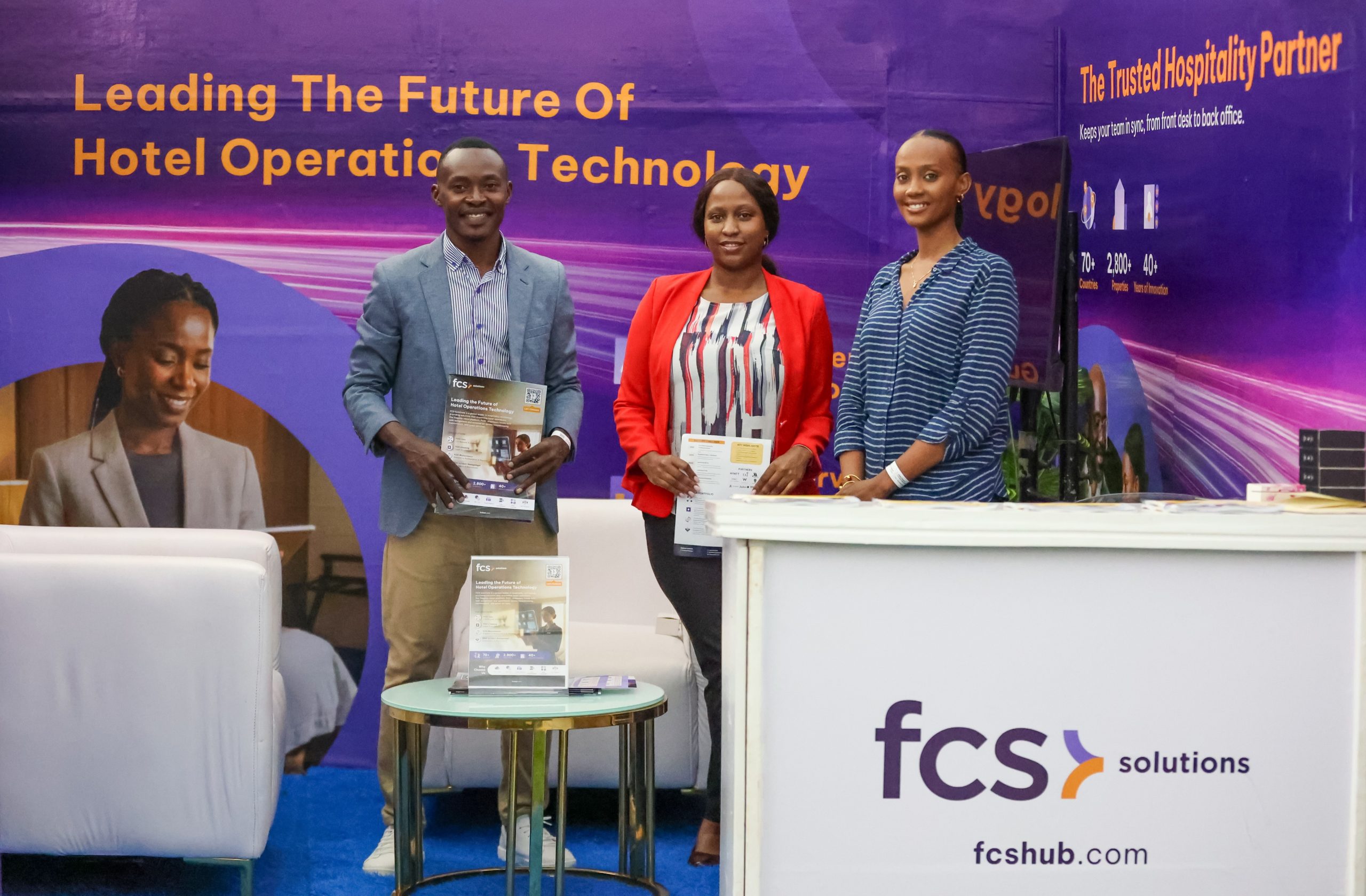JAFAR AJENA OF FCS SOLUTIONS POSES WITH COLLEAGUE AT THE FCS BOOTH