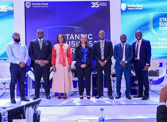 Tunde Thorpe (2 L) , Executive Head of Business and Commercial Banking pose for a group photo with panelists during the Regional Forum in Kampala.JPG